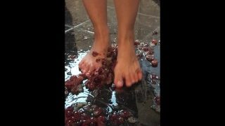 18-year-old Chinese girl with slender bare feet crushing grapes